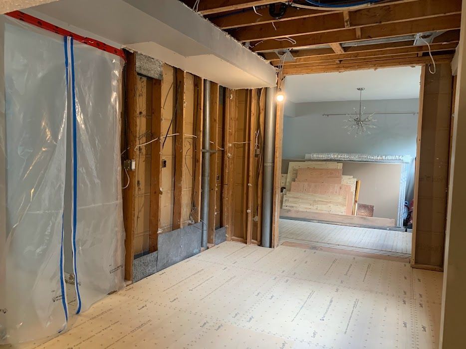 A room with wooden walls and a wooden floor under construction.