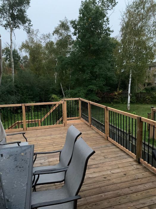A wooden deck with a table and chairs on it