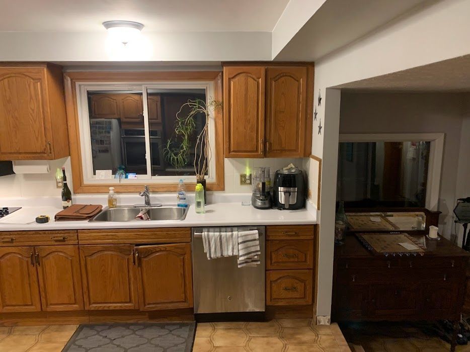 Kitchen with oak cabinets, stainless steel appliances, and a window over the sink.