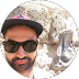 A man with a beard wearing sunglasses and a hat.