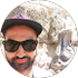 A man with a beard wearing sunglasses and a hat.