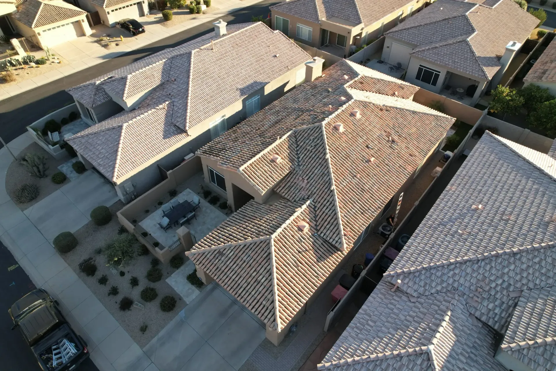 An aerial view of a residential area with a lot of houses and roofs.
