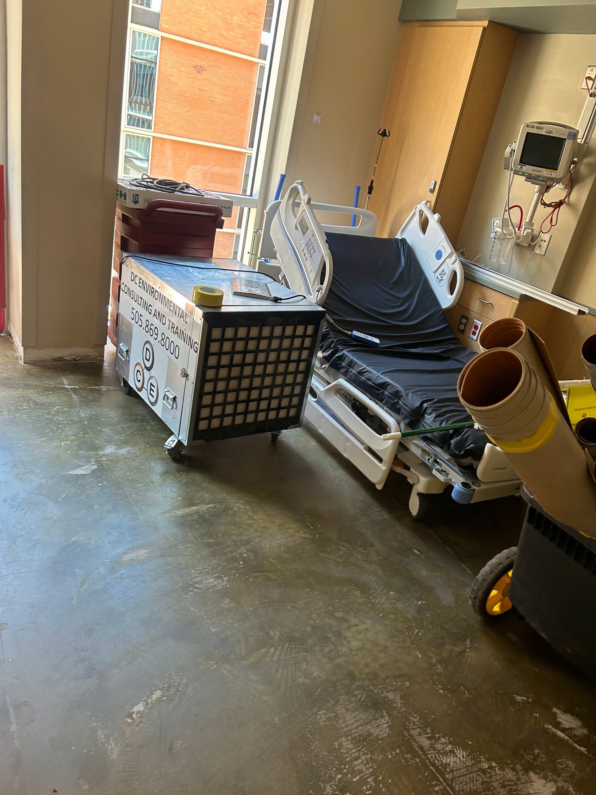 Medical room with a hospital bed, equipment cart, and equipment.