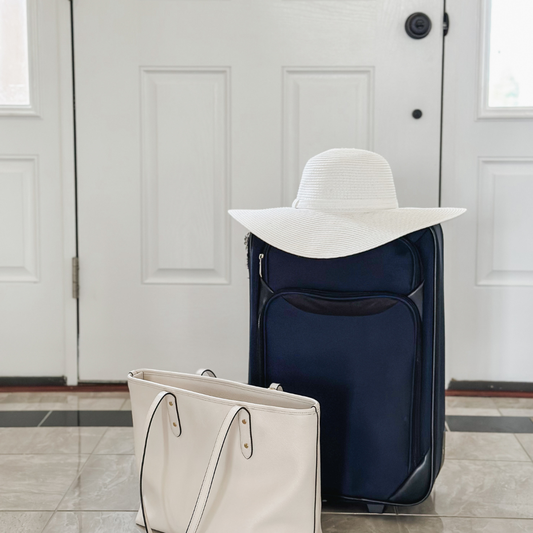 blue suitcase sitting by the door with a hat and purse, the Lord says get ready to go!