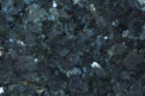 A close up of a black granite counter top.