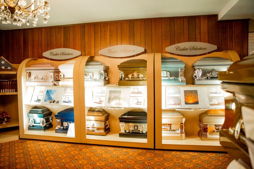 There are many different types of coffins on display in this room.