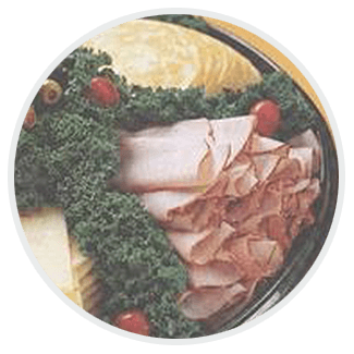 A plate of meat and vegetables in a circle on a table.
