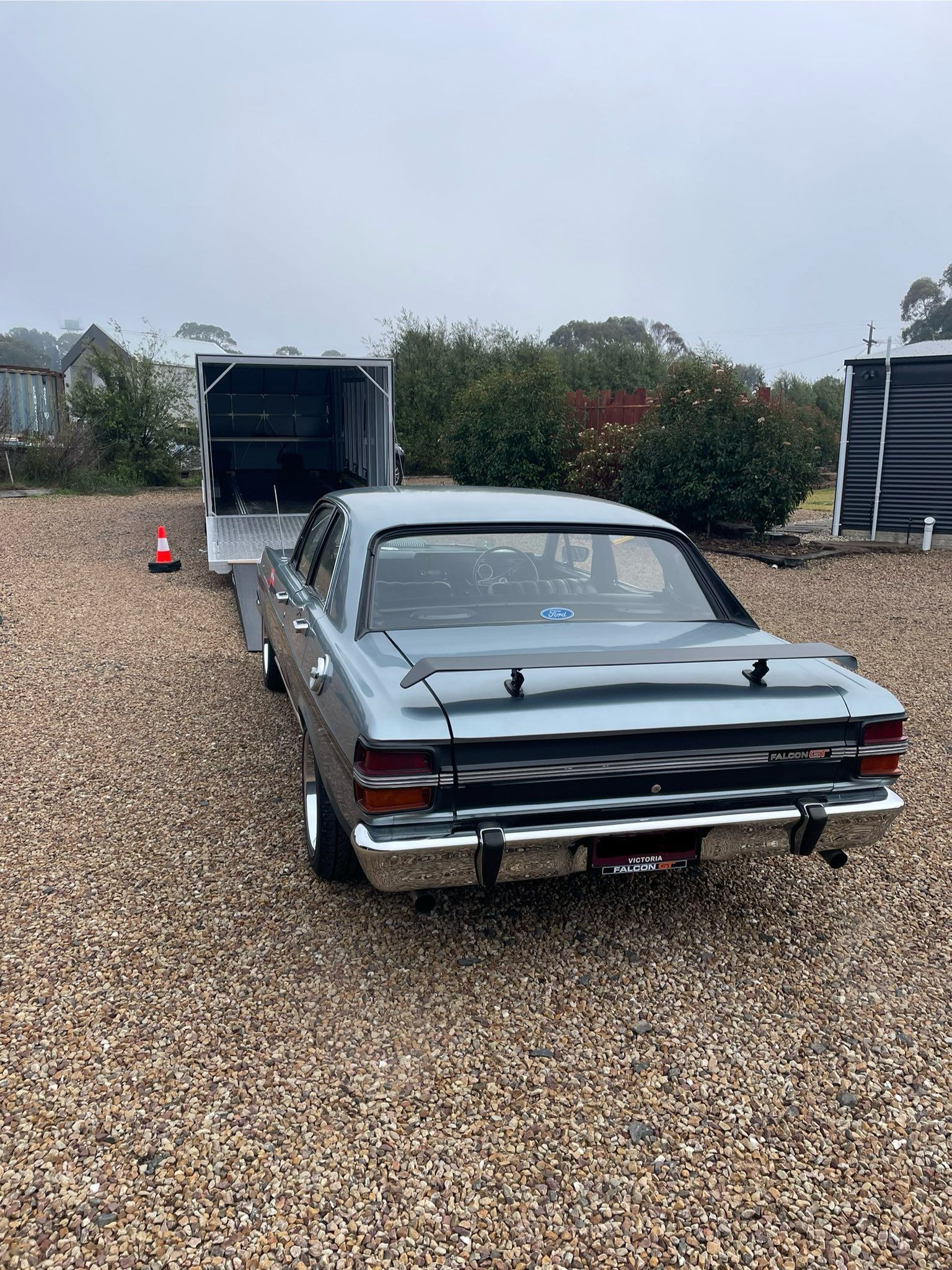 Yellow Sports Car Being Loaded onto A Trailer on A Street — Full Throttle Enclosed Car Transport in Kilmore, VIC