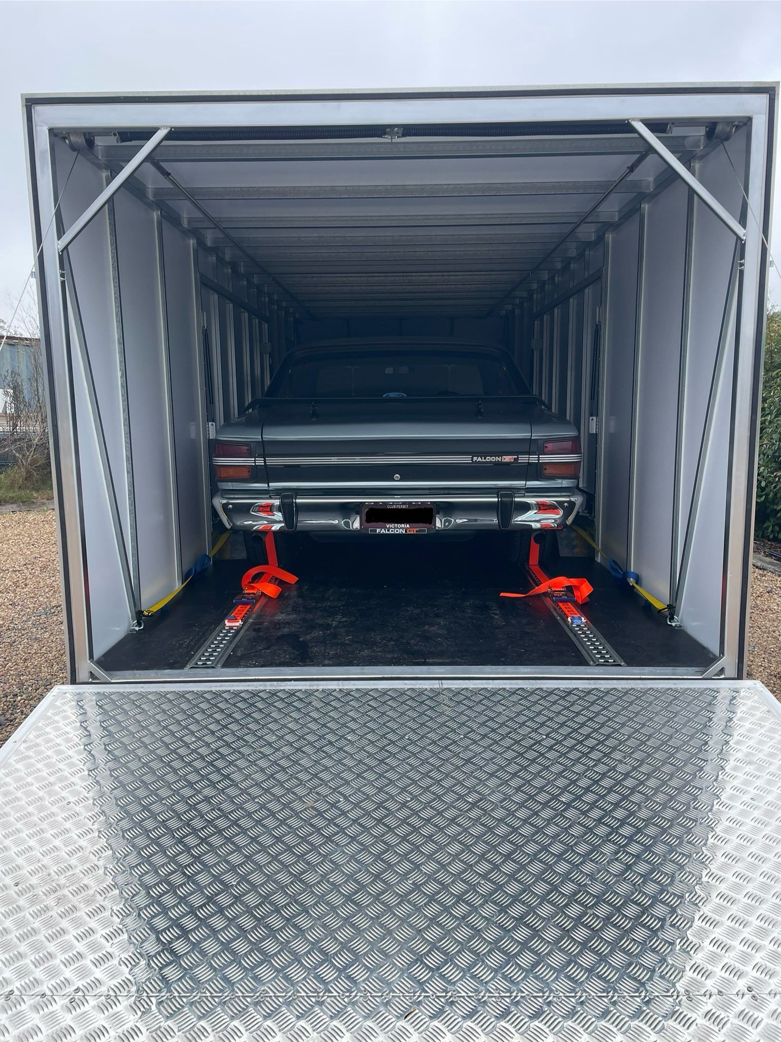 Classic car secured inside a transport trailer, secured with red straps — Full Throttle Enclosed Car Transport in Kilmore, VIC
