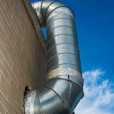Pressure Pros Soft Washing LLC | person is cleaning a gutter from leaves on a roof.