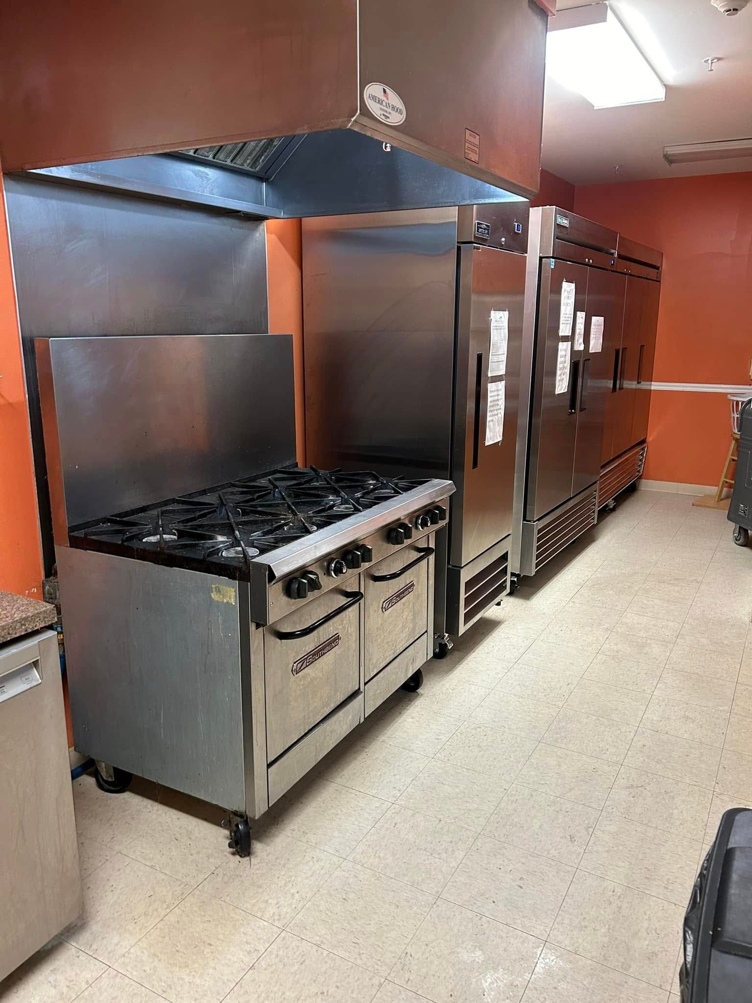 Pressure Pros Soft Washing LLC | man is painting the side of a building with a crane.