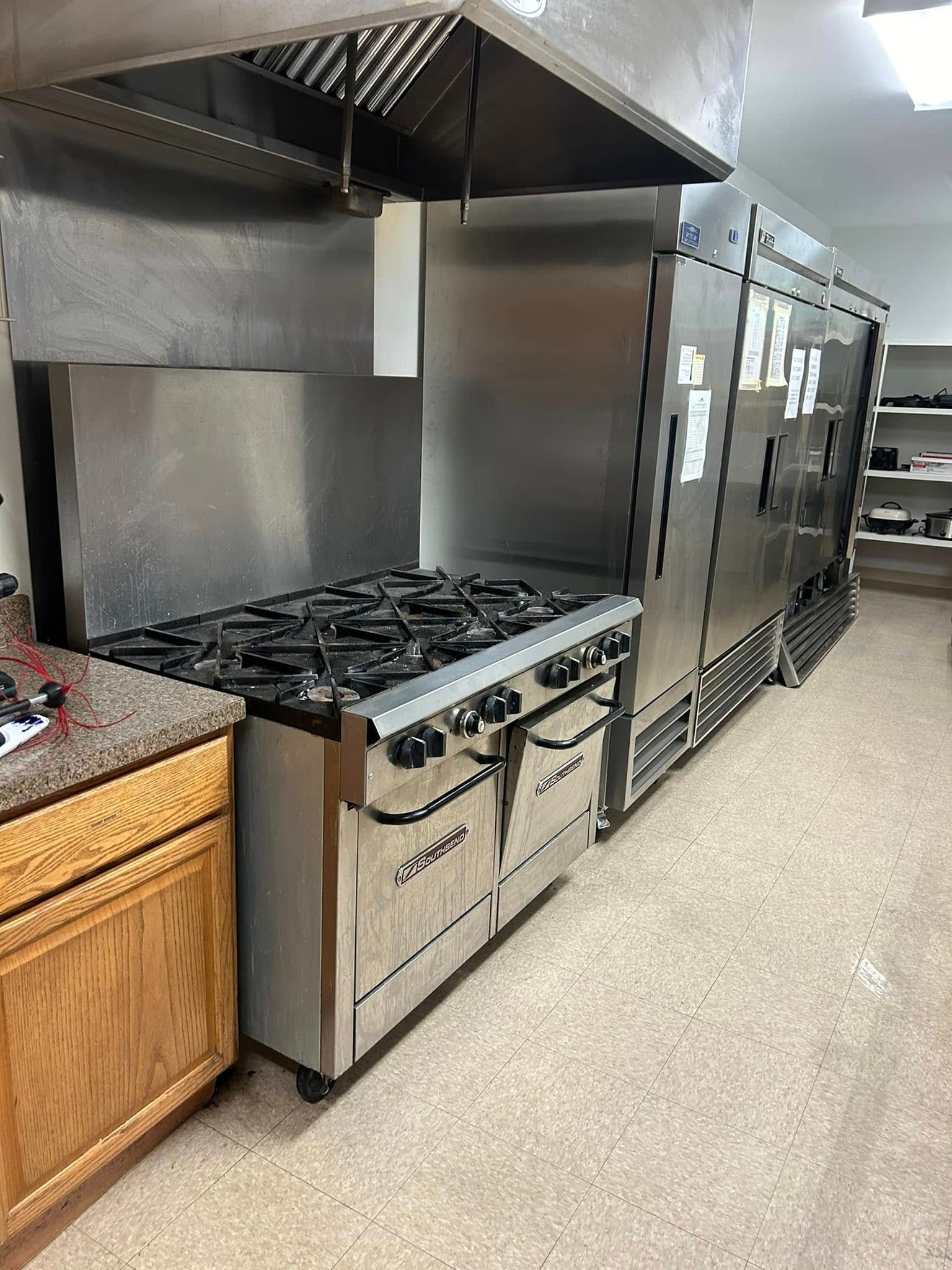 Pressure Pros Soft Washing LLC | hose is connected to a machine that is cleaning a concrete floor.