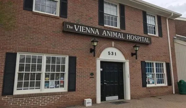 The vienna animal hospital is a brick building with black shutters.