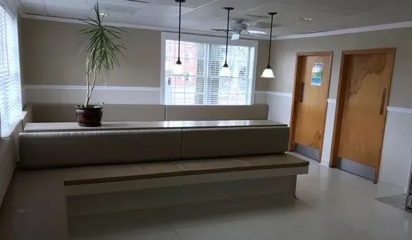 There is a bench in the middle of the room.