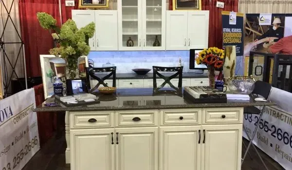 A kitchen with white cabinets and a granite counter top.