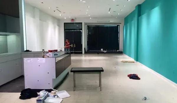 A large empty room with blue walls and a table.