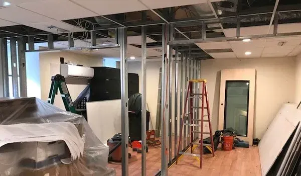 A room that is being remodeled with a ladder in it.