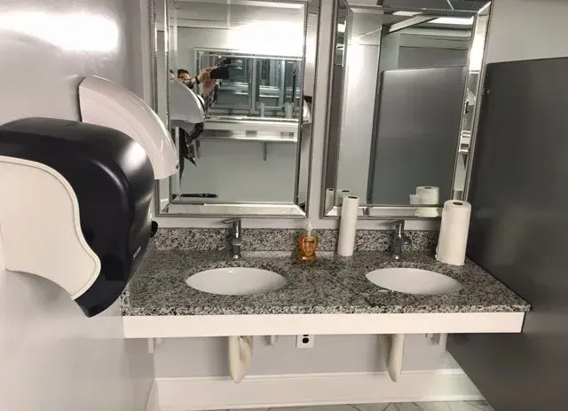 A bathroom with two sinks and a mirror.