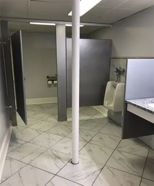A public restroom with a urinal and a sink.