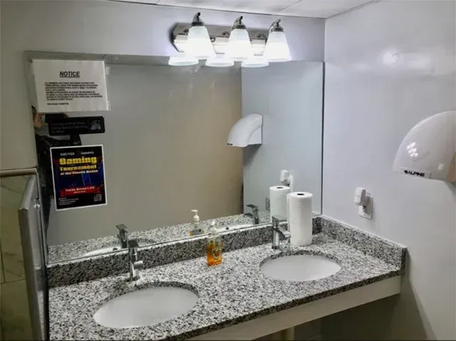 A bathroom with two sinks and a mirror.