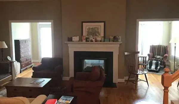 There is a fireplace in the middle of the living room.