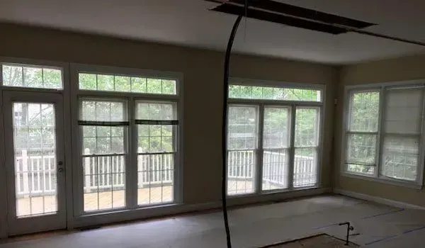 An empty room with a lot of windows and doors.