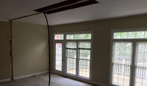 A room with a lot of windows and a ceiling fan.