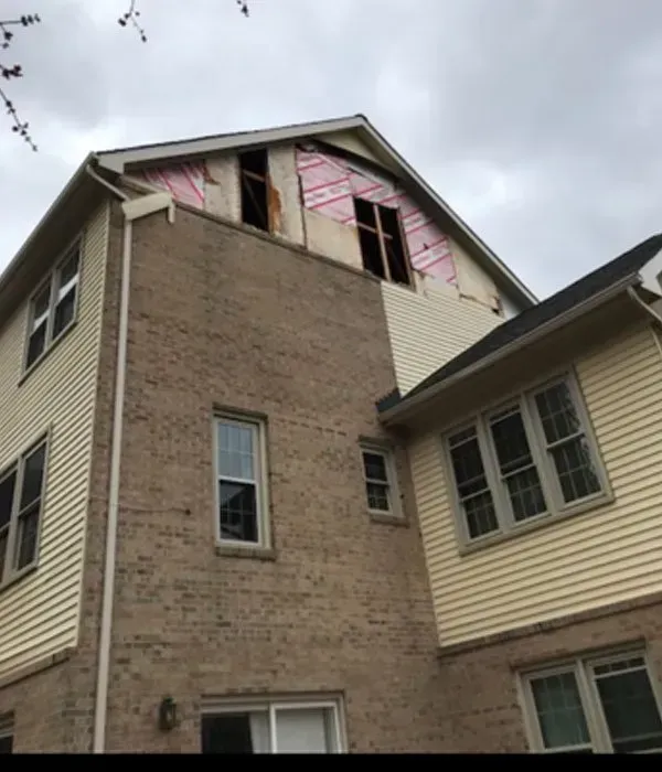 A house with a roof that has been damaged.