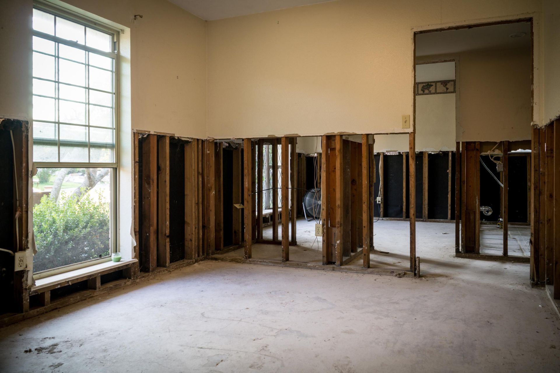 An empty room with a lot of windows and wooden walls.