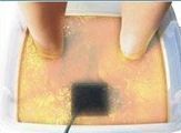 Feet in a water bath, dark square at the bottom, water turning yellow.