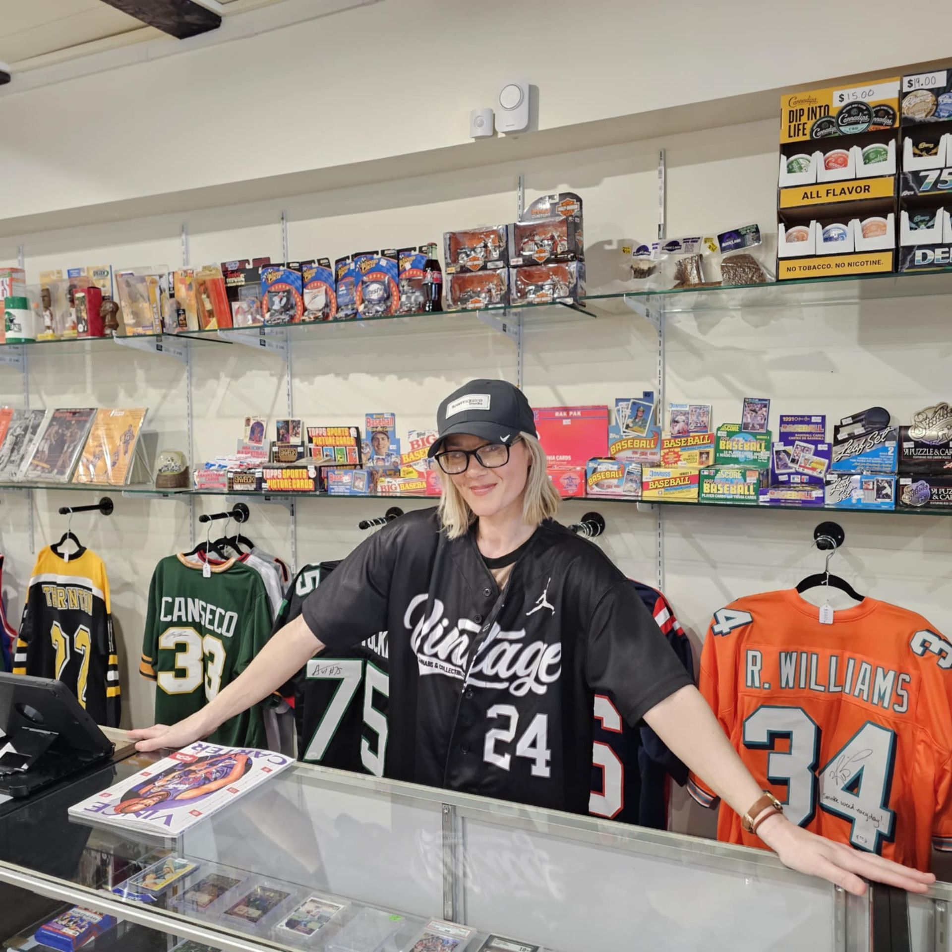 A woman wearing a vintage jersey is standing in a store