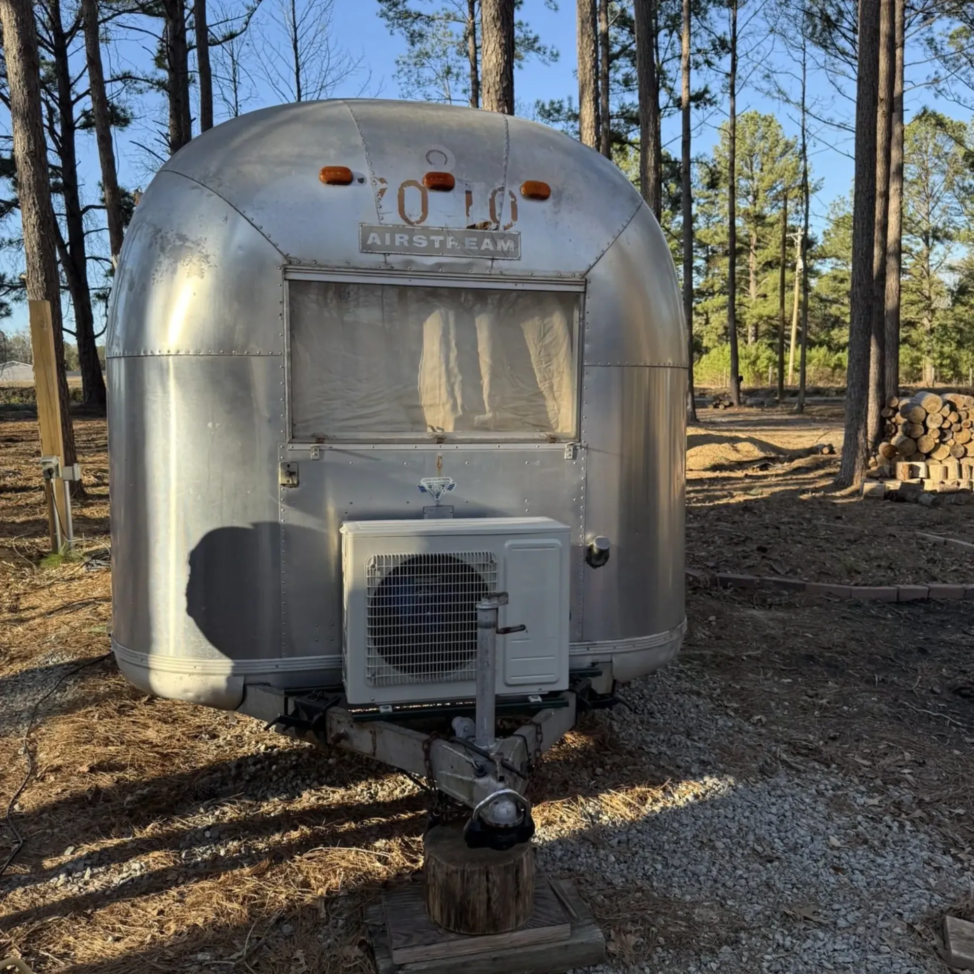 LCS Heating and Cooling - A silver airstream trailer is parked in the woods