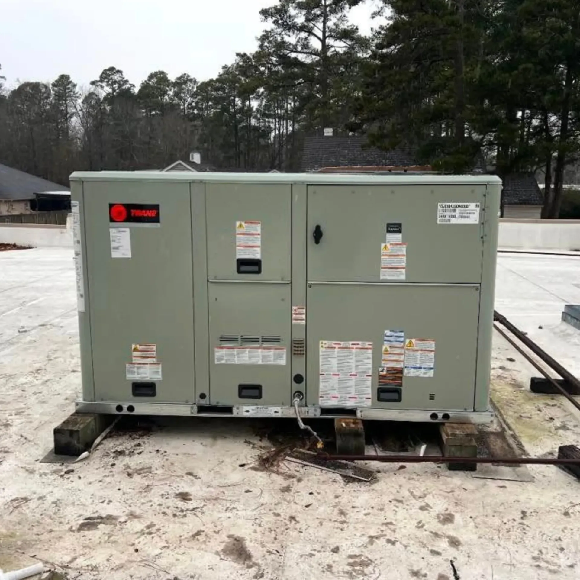 LCS Heating And Cooling - A trident air conditioner is sitting on the roof of a building