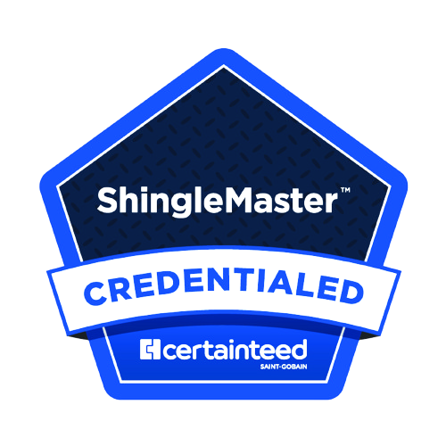 Two people on ladders working on the roof of a house with grey siding and shingles.