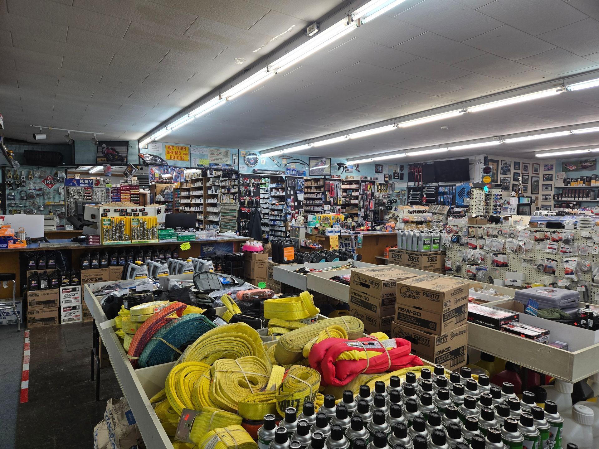 A bunch of tires are stacked on top of each other in a store.