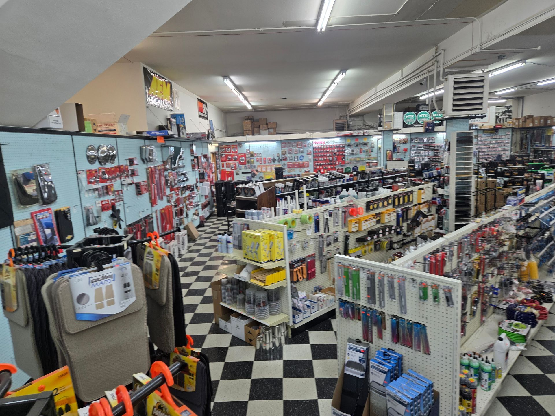 The inside of a hardware store with a checkered floor.