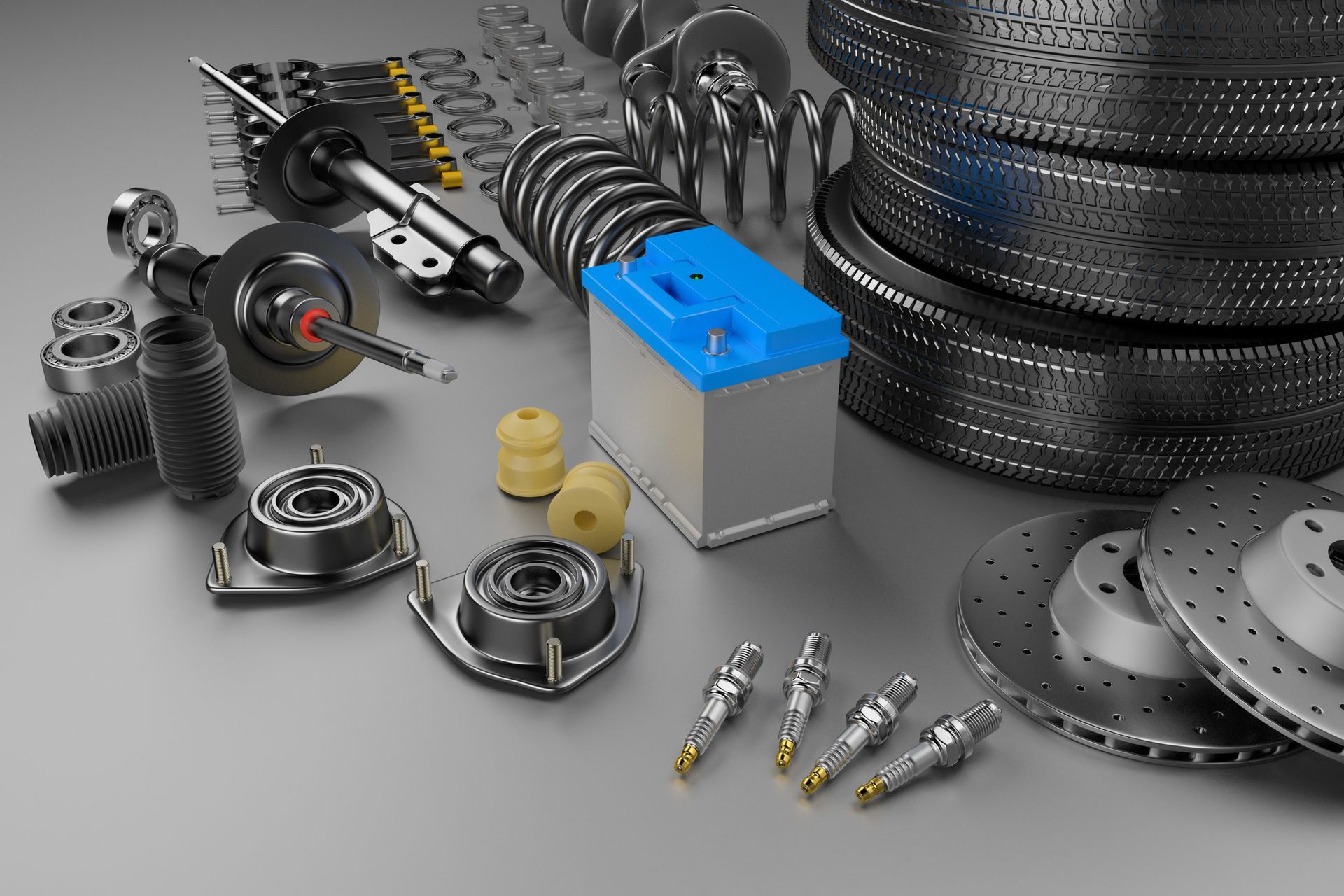Assorted auto parts displayed on a grey background for vehicle repairs and maintenance.
