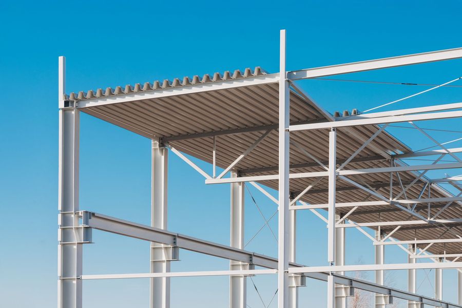 A building under construction with a blue sky in the background.