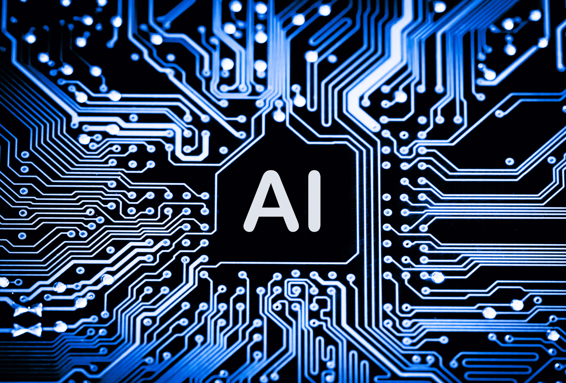 Close up of a blue circuit board with an AI processor chip at the center representing AI technology
