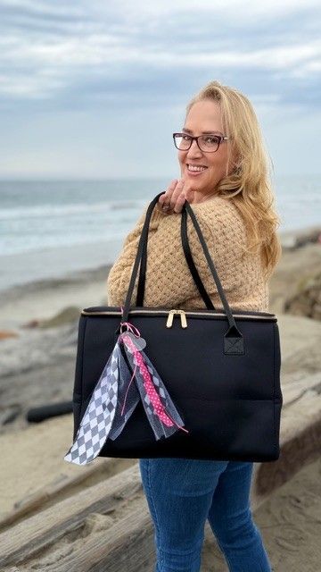 Woman carrying The Stever Co insulated tote bag at the beach