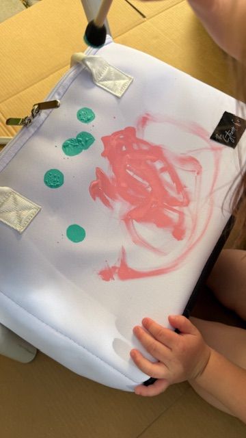 child painting The Stever Co Mom’s Favorite insulated tote with pink and green paint for handprint gift