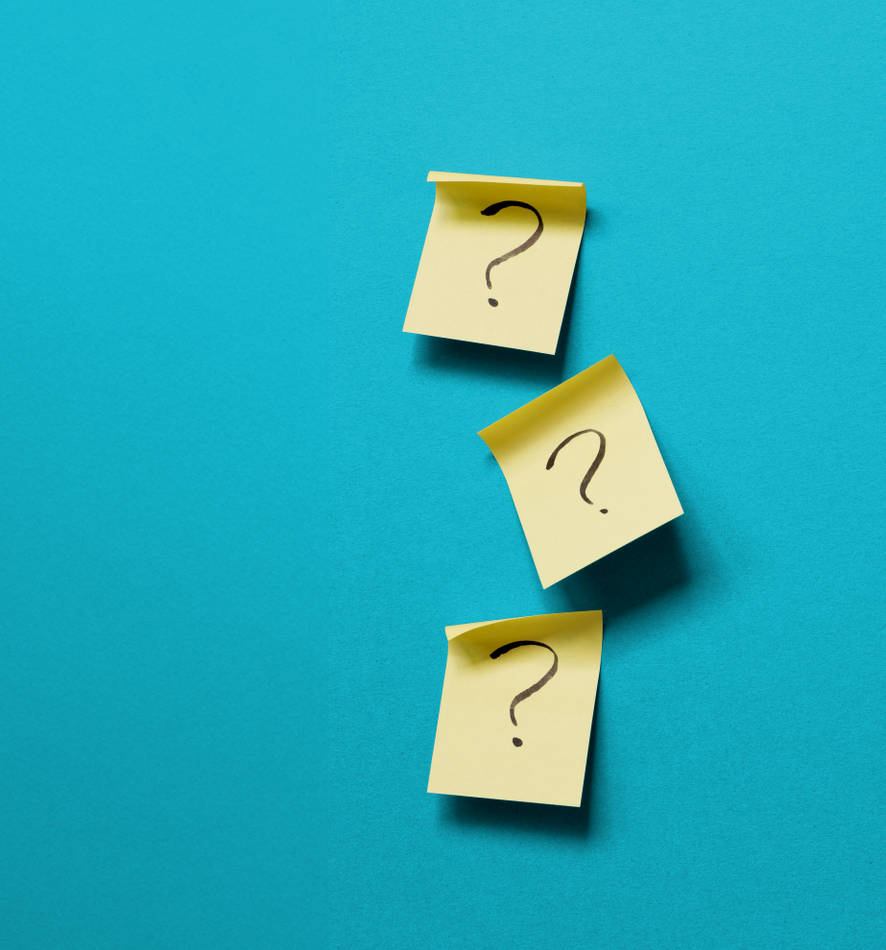 Three yellow sticky notes with question marks on them on a blue background