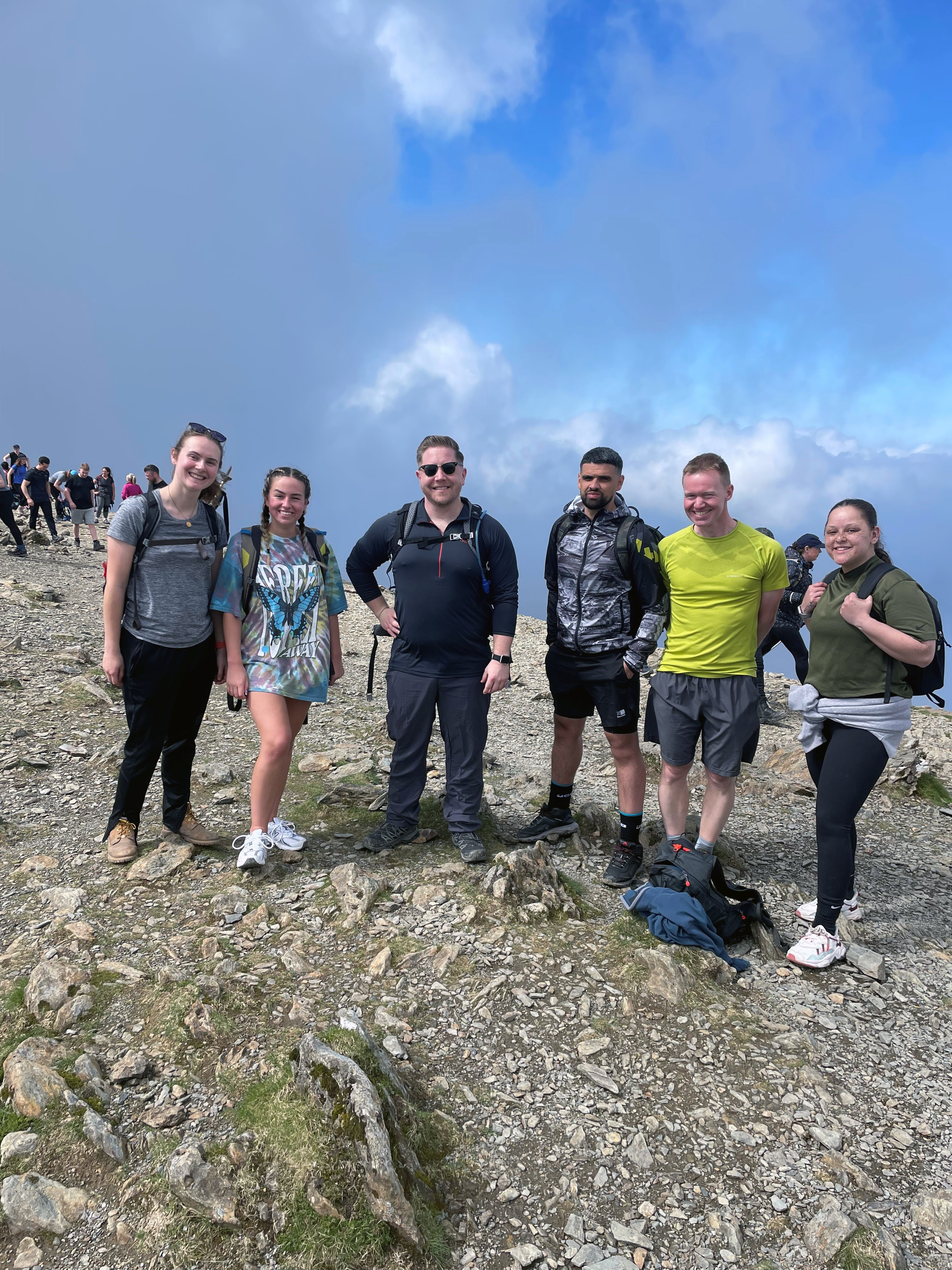 A group of people are standing on top of Snowdon