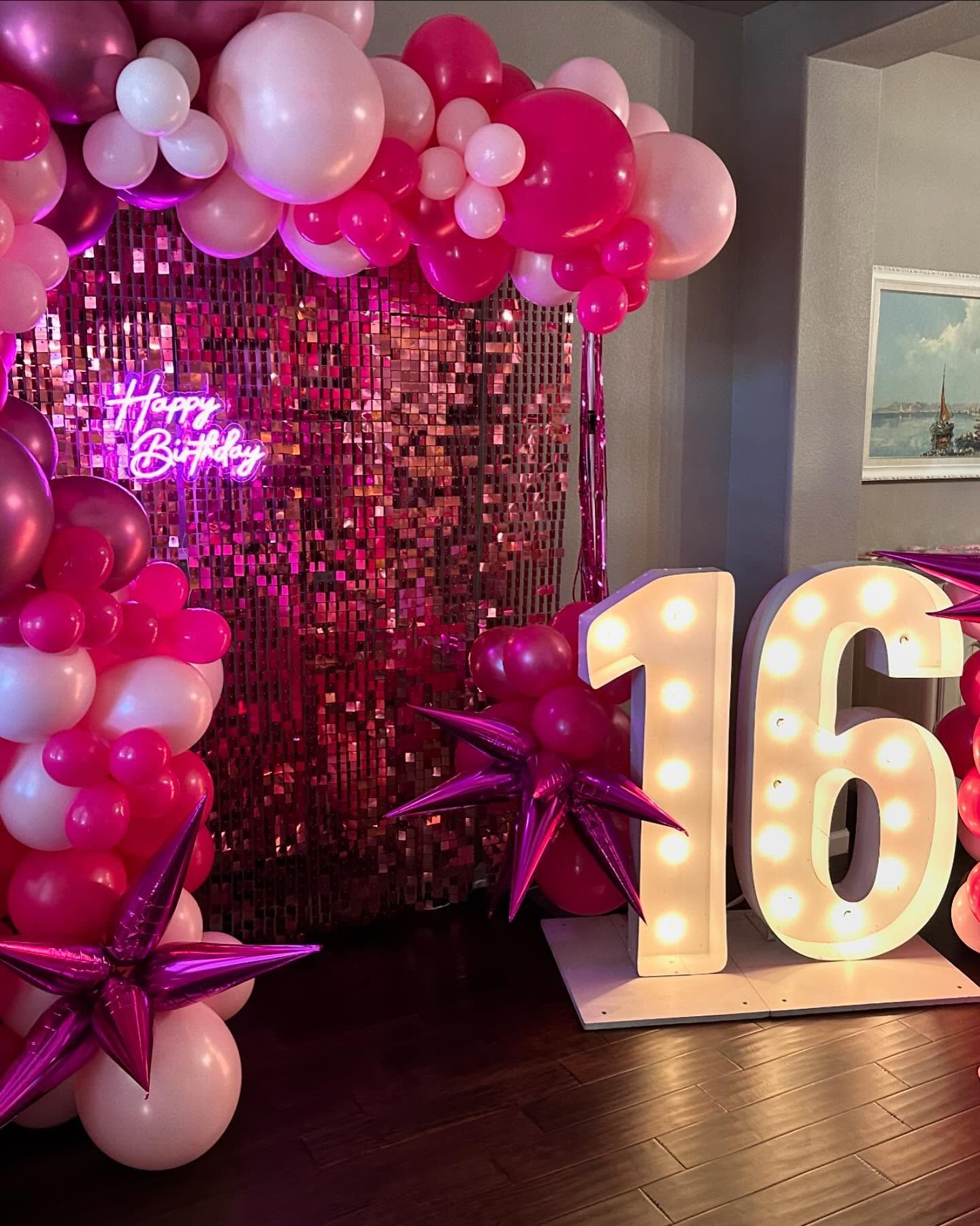 Pink-themed sweet sixteen party: balloon arch, light-up