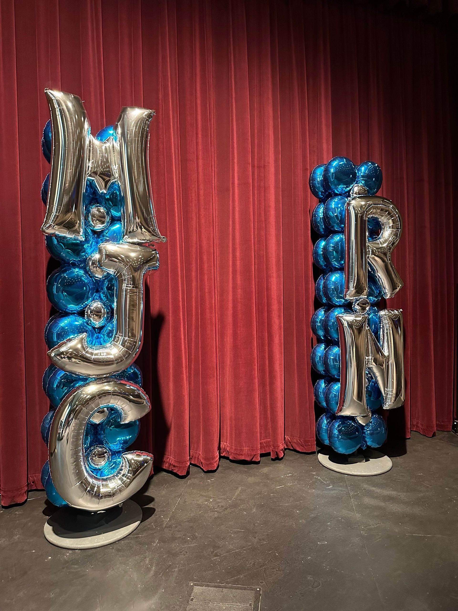 Columns of blue and silver balloons spelling 