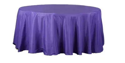 Round table covered with a purple tablecloth.