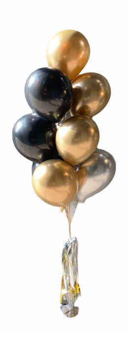A bunch of metallic gold, black, and silver balloons tied together with a silver ribbon.