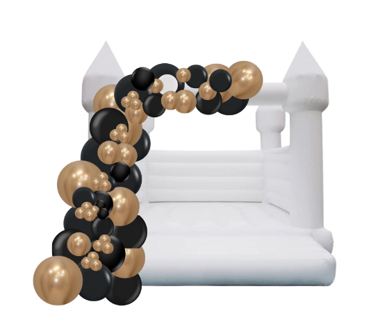 White bounce house with black and gold balloon arch.
