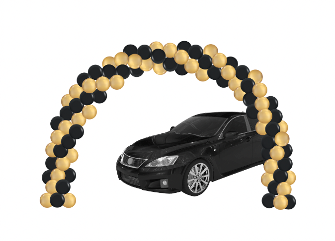 Black car driving under a gold and black balloon arch.