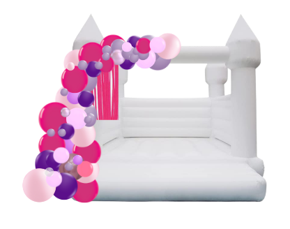 White bouncy castle with a pink and purple balloon arch.